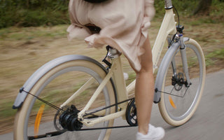 Urban electric bike complying with UK 250W EAPC regulations being ridden on a city street.