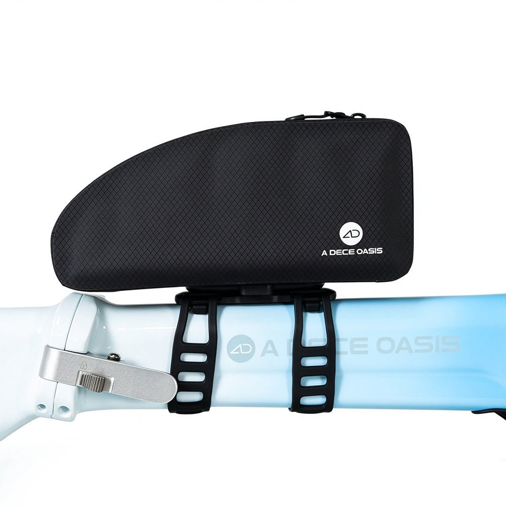 The black ADO CB10 frame bag mounted securely on a light blue bicycle top tube using the adjustable silicone straps of the AQS Mag quick-release mounting system.