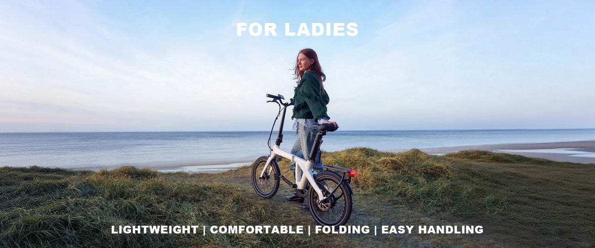 Woman with a white lightweight folding e-bike on a coastal grass field.